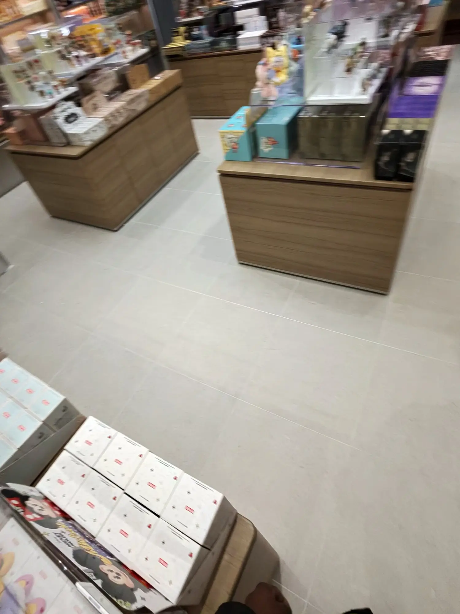 An open retail floor, clean tile between stocked islands.