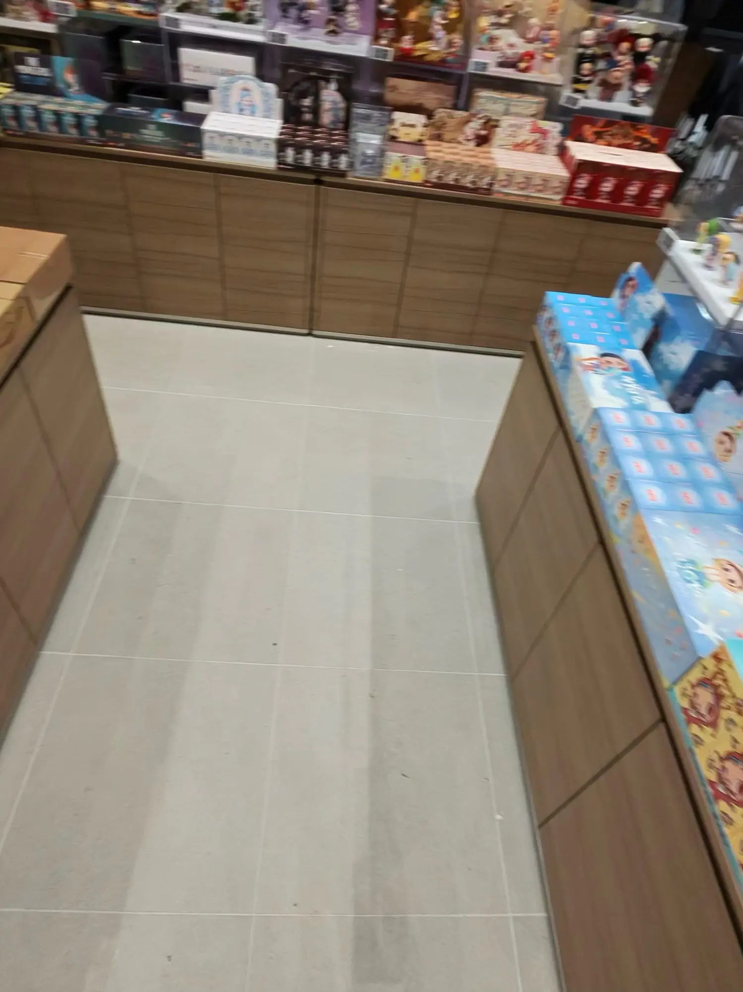 A clean tile aisle between stocked fixtures.