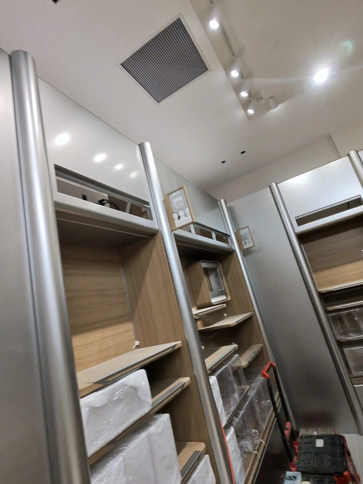 Unfinished fixtures with protective wrap and a tool cart.
