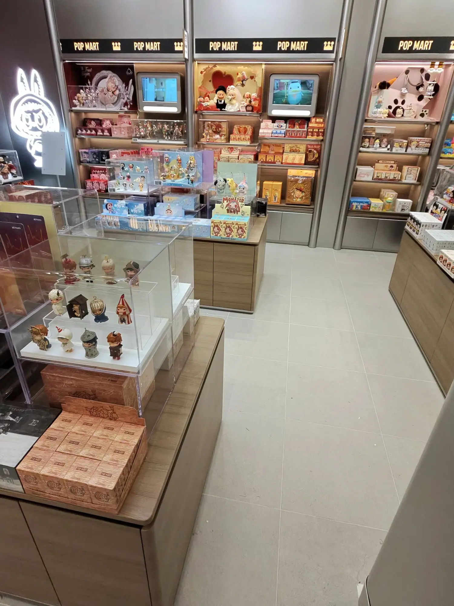Pop Mart store on opening, glass cases and shelving clean.
