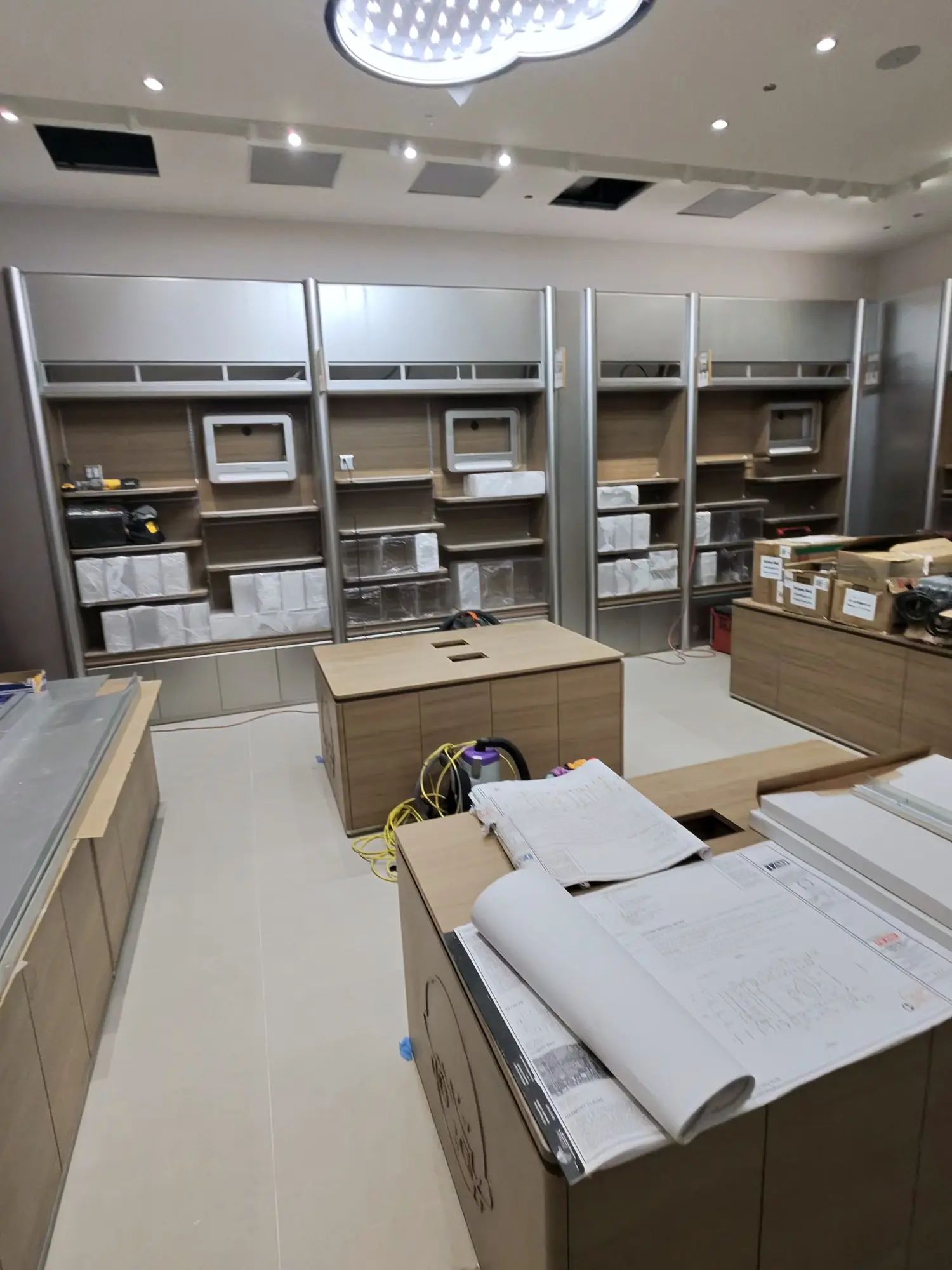 Pop Mart, Arizona, mid fit-out: empty fixtures, boxes and drawings on the counters.